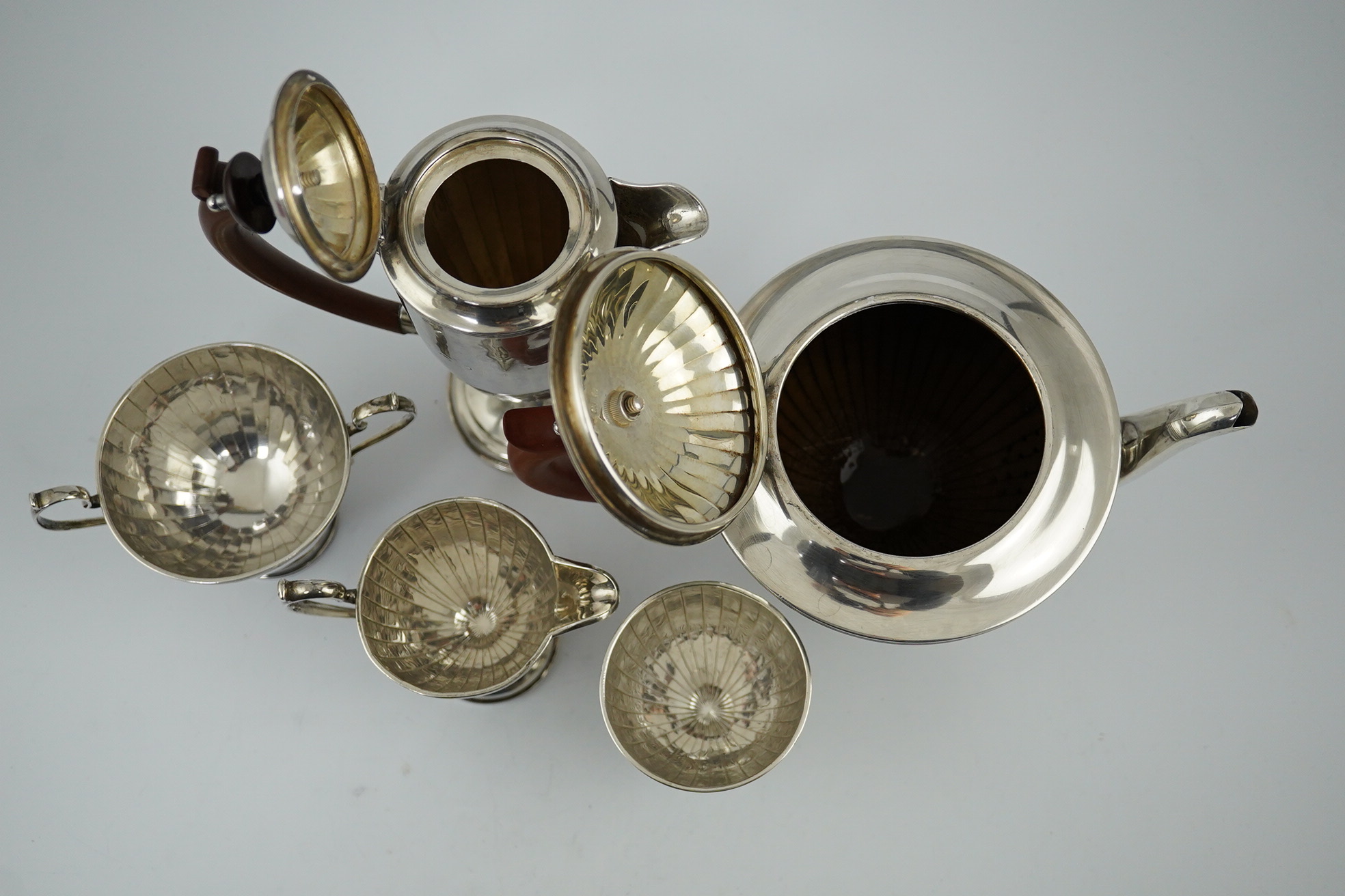 A George V panelled silver five piece tea set by Adie Brothers